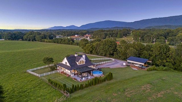 birds eye view of property featuring a mountain view and a rural view