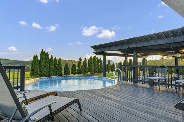 view of swimming pool with a deck