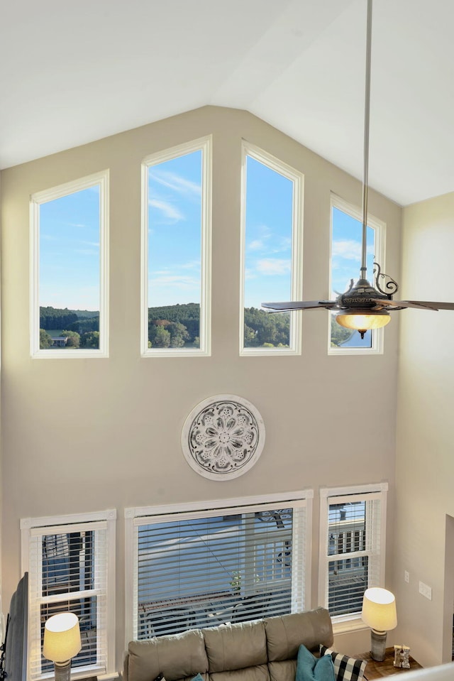 living room with ceiling fan and vaulted ceiling