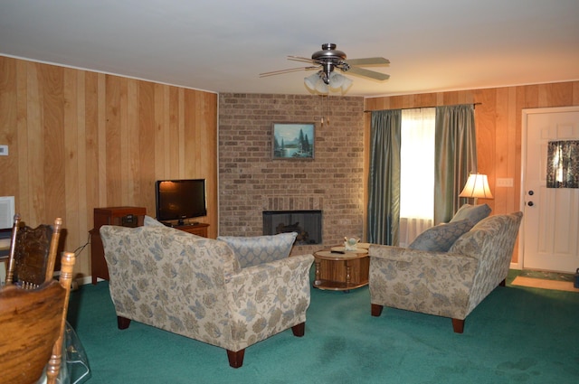 living room with ceiling fan, carpet, a fireplace, and wooden walls