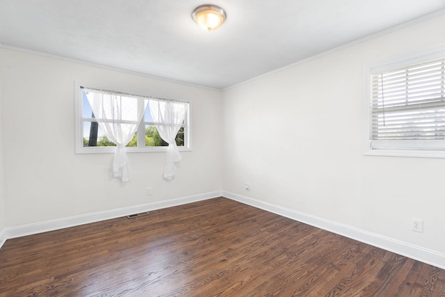 empty room featuring crown molding and dark wood-type flooring