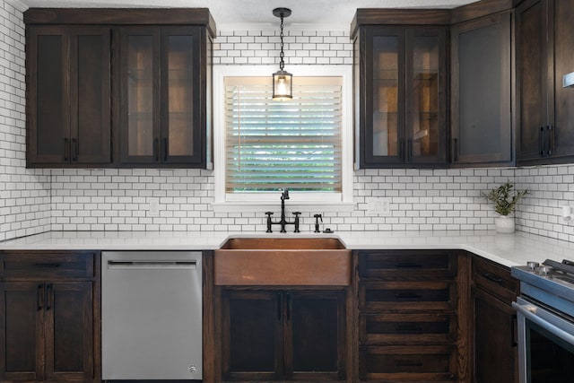 kitchen with decorative backsplash, appliances with stainless steel finishes, pendant lighting, and sink