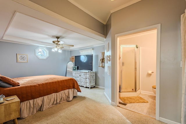 bedroom featuring ceiling fan, ensuite bathroom, crown molding, and light carpet