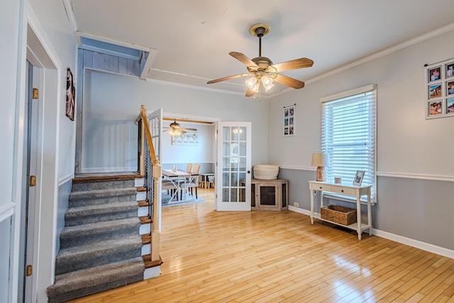 interior space with ceiling fan, ornamental molding, and hardwood / wood-style floors