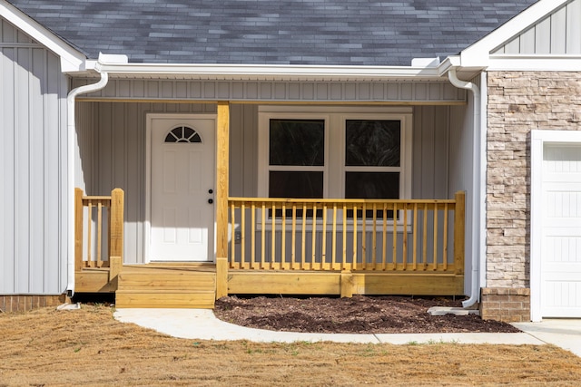 view of exterior entry featuring covered porch