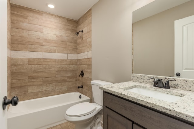 full bathroom with toilet, vanity, and tiled shower / bath