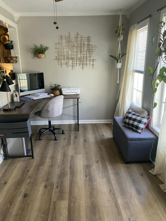 home office featuring crown molding, baseboards, and wood finished floors