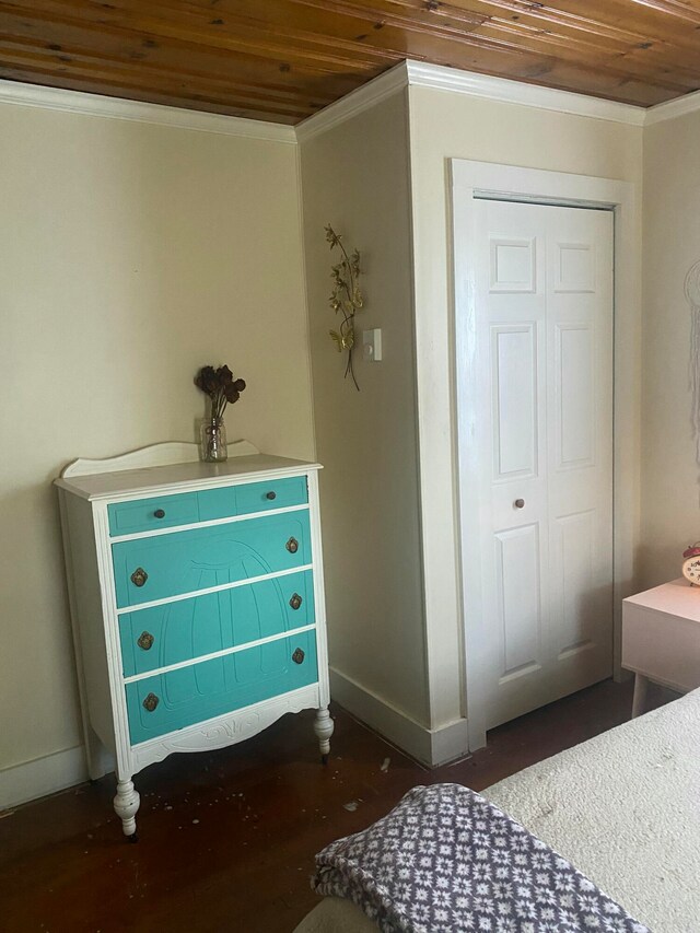 bedroom with ornamental molding, wooden ceiling, baseboards, and wood finished floors