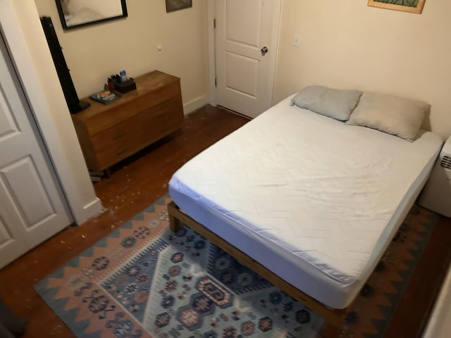 bedroom with dark wood-style flooring