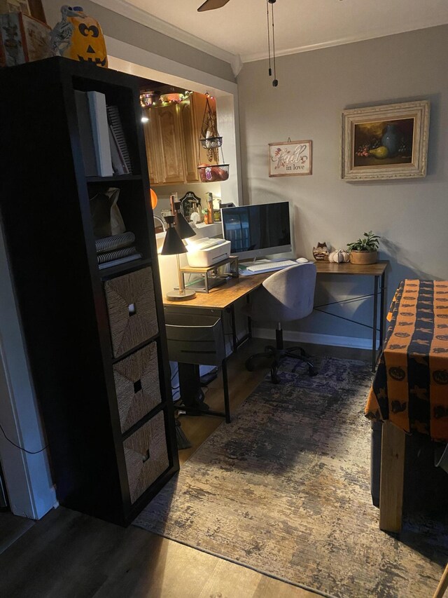 office featuring a ceiling fan, ornamental molding, and wood finished floors