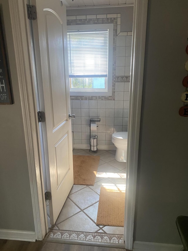 bathroom featuring tile walls, toilet, and tile patterned floors