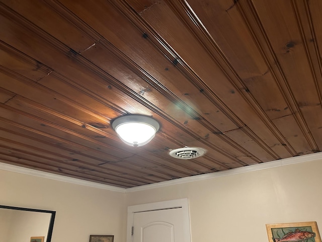 interior details with wood ceiling, visible vents, and crown molding