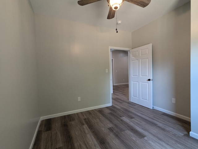 empty room with ceiling fan and dark wood-type flooring