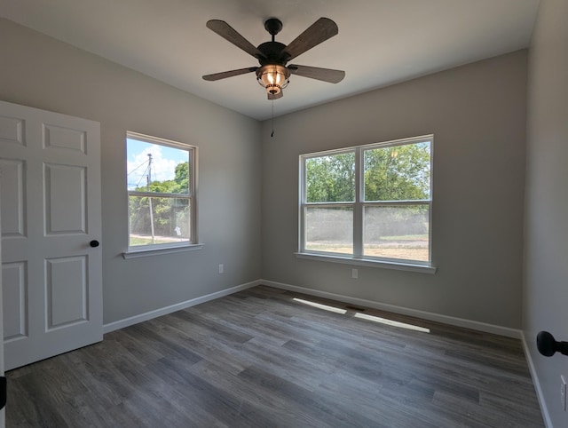 empty room featuring dark hardwood / wood-style floors and ceiling fan