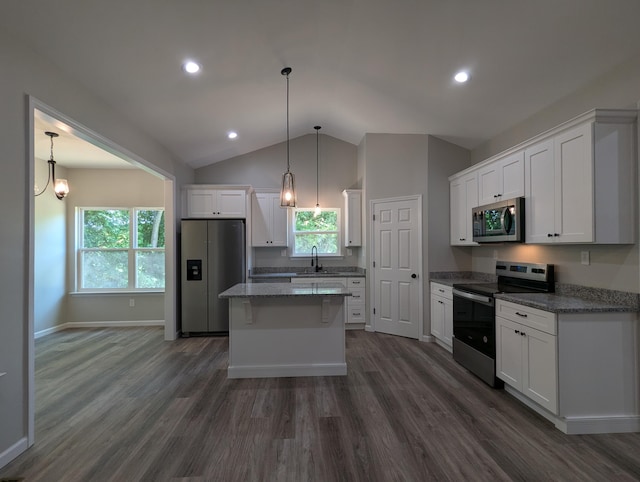 kitchen with white cabinets, decorative light fixtures, stainless steel appliances, and sink