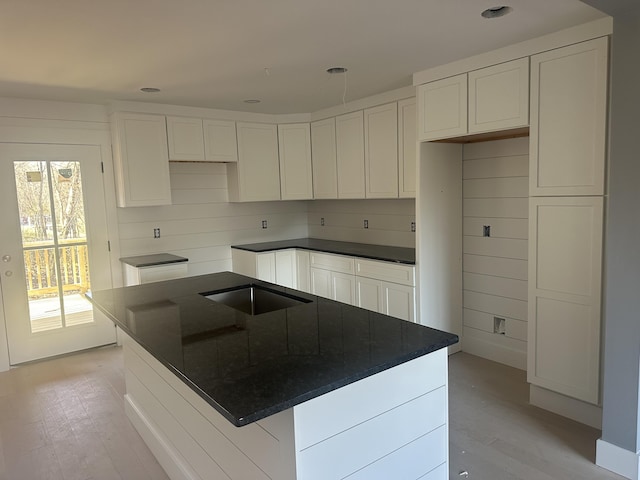 1775 Lenox Dr NW, Cleveland, TN 37312 - kitchen with light wood-style floors, a kitchen island, white cabinets, and a sink