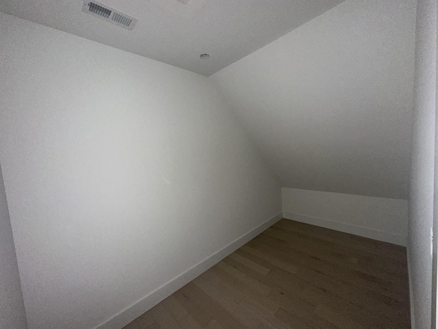 1775 Lenox Dr NW, Cleveland, TN 37312 - additional living space with baseboards, visible vents, wood finished floors, and vaulted ceiling