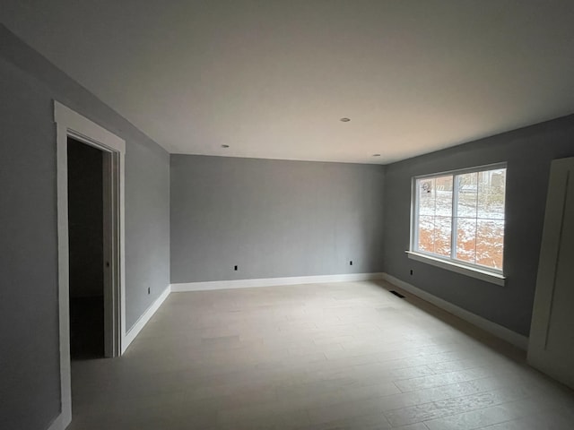 unfurnished room featuring light hardwood / wood-style flooring