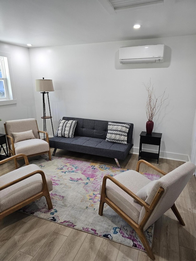 living room featuring hardwood / wood-style floors and a wall mounted AC