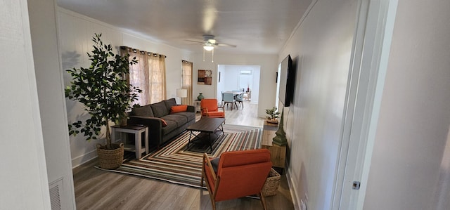 living room featuring ceiling fan and hardwood / wood-style flooring