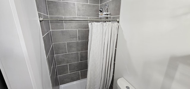 bathroom featuring toilet and walk in shower