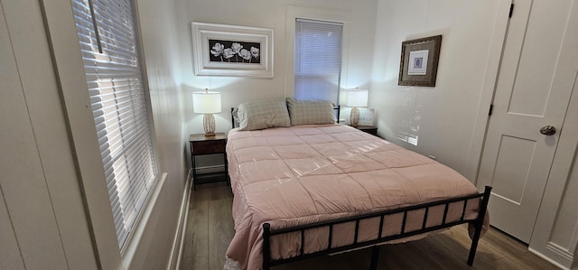 bedroom with dark hardwood / wood-style floors