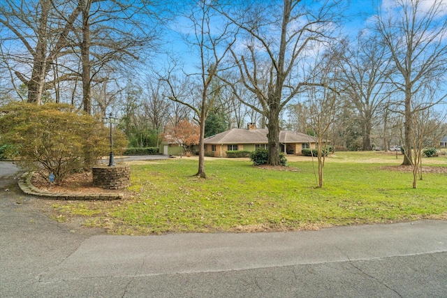 ranch-style home featuring a front yard