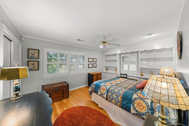 bedroom featuring crown molding, ceiling fan, and light wood-type flooring