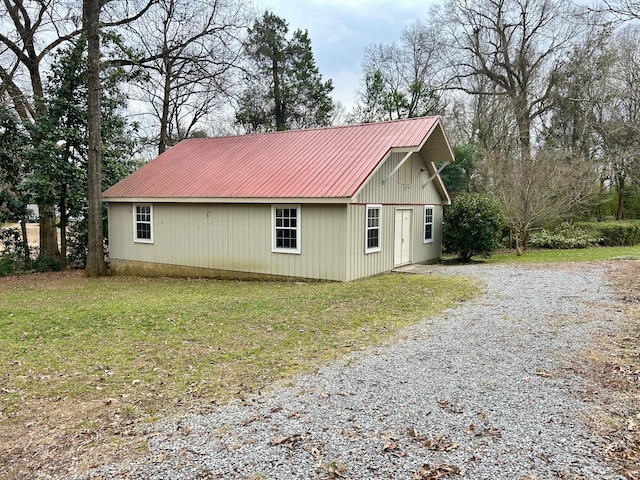 view of side of property with a lawn