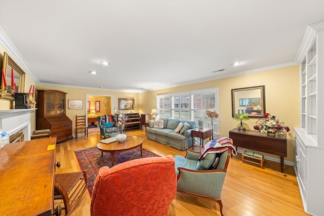 living room featuring crown molding and light hardwood / wood-style flooring