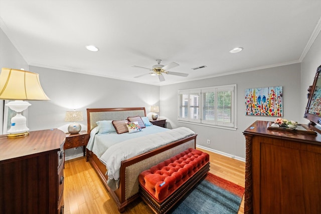 bedroom with ornamental molding, ceiling fan, and light wood-type flooring