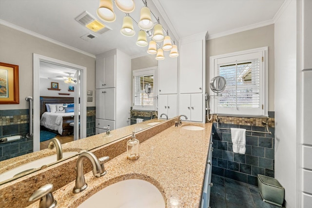 bathroom featuring crown molding, tile walls, vanity, and ceiling fan