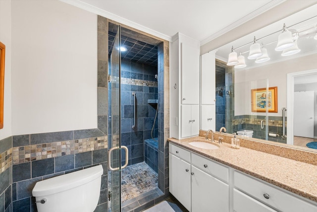 bathroom with tile walls, toilet, vanity, walk in shower, and crown molding