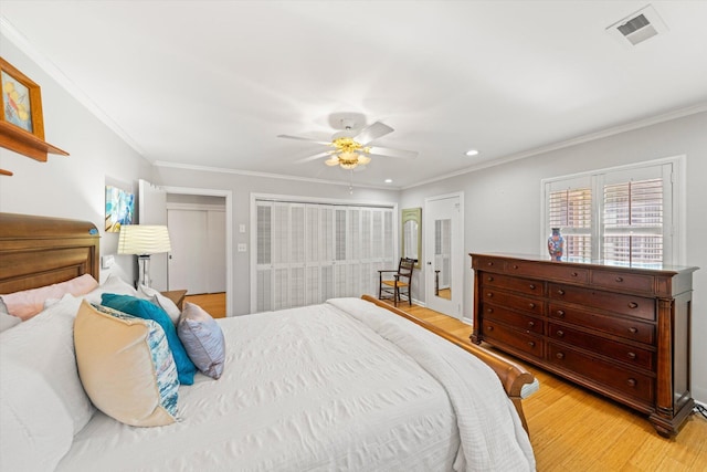 bedroom featuring crown molding, ceiling fan, and light wood-type flooring