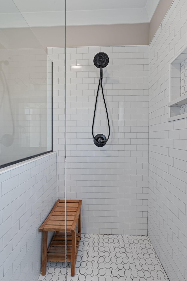 bathroom featuring tile walls and tiled shower