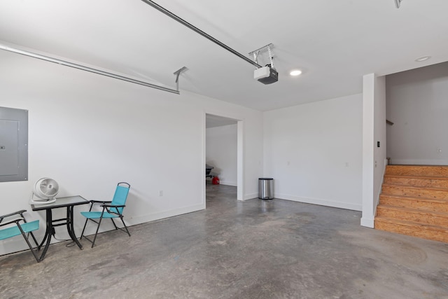 garage with baseboards, electric panel, and a garage door opener