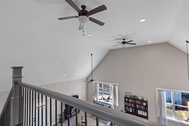 hallway featuring high vaulted ceiling, recessed lighting, and an upstairs landing