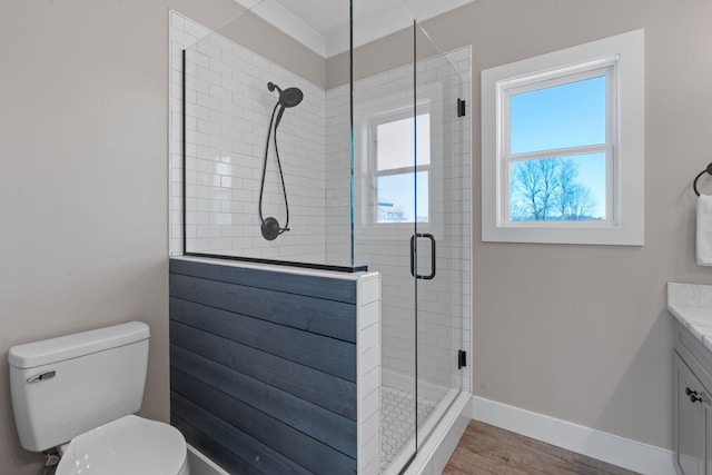 full bathroom with toilet, wood finished floors, vanity, baseboards, and a shower stall