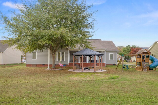 back of house with a gazebo, a patio area, a playground, and a yard