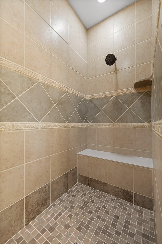 bathroom with a tile shower