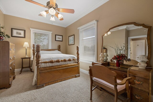 carpeted bedroom with ceiling fan and crown molding