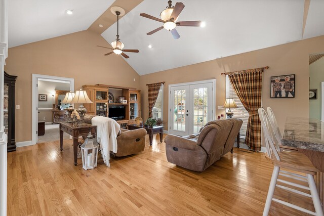 living room featuring ceiling fan, french doors, high vaulted ceiling, and light hardwood / wood-style floors