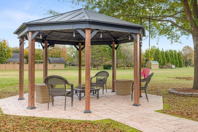 view of patio with a gazebo and a shed