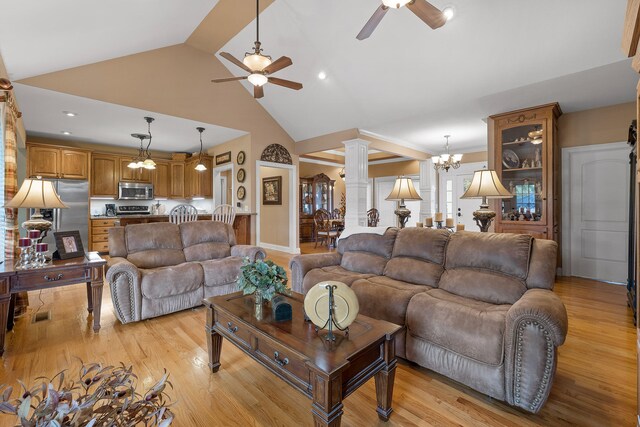 living room featuring ornate columns, light hardwood / wood-style flooring, high vaulted ceiling, and ceiling fan with notable chandelier