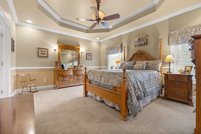 bedroom featuring carpet flooring, a raised ceiling, ceiling fan, and ornamental molding