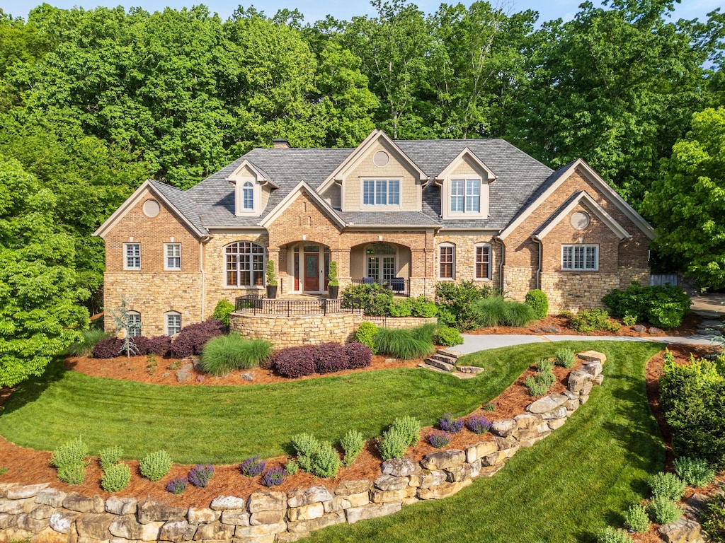 view of front of property with covered porch and a front lawn