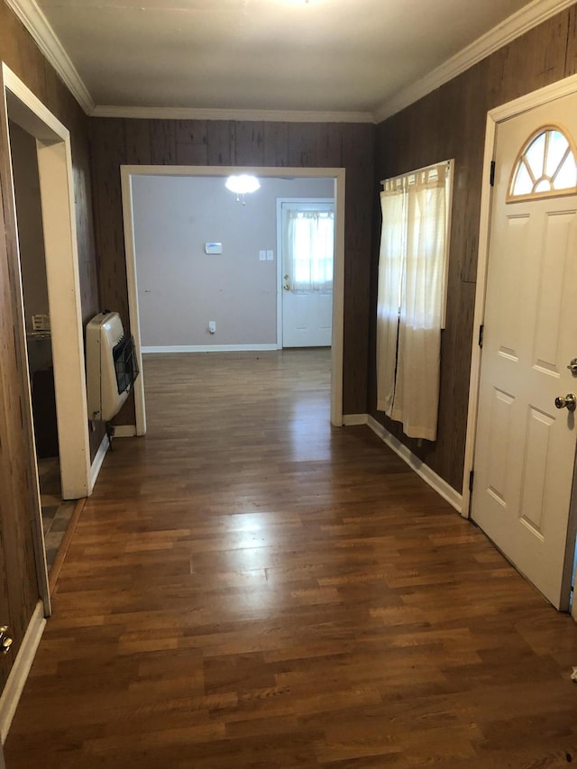 entryway with heating unit, baseboards, dark wood finished floors, and crown molding