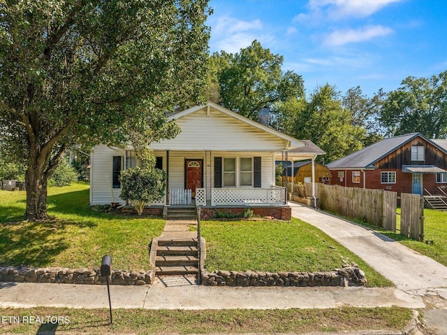 bungalow-style house with a front yard and a porch