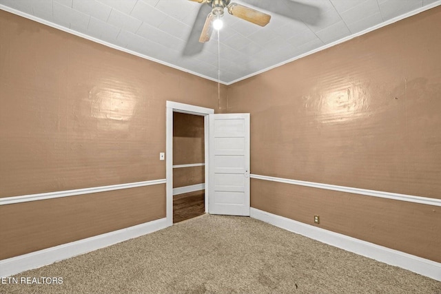 unfurnished room with crown molding, ceiling fan, and carpet flooring