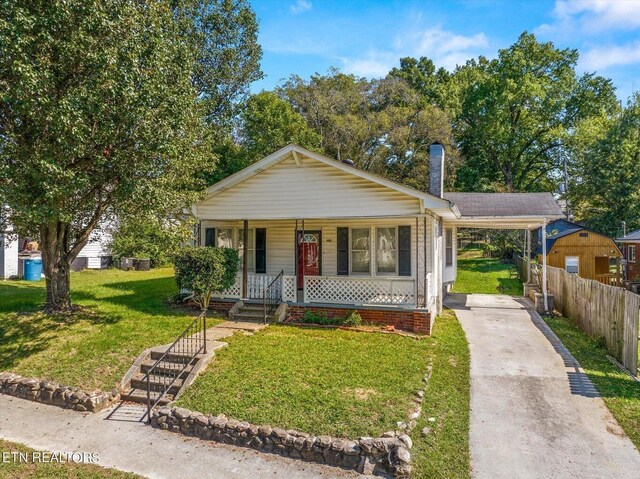 view of front of property with a porch and a front yard